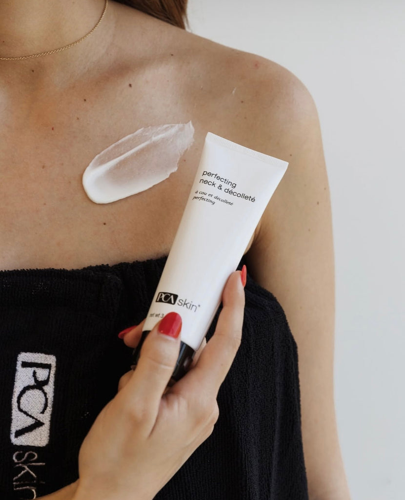 Person applying PCA Skin cream to their shoulder with a visible swatch.